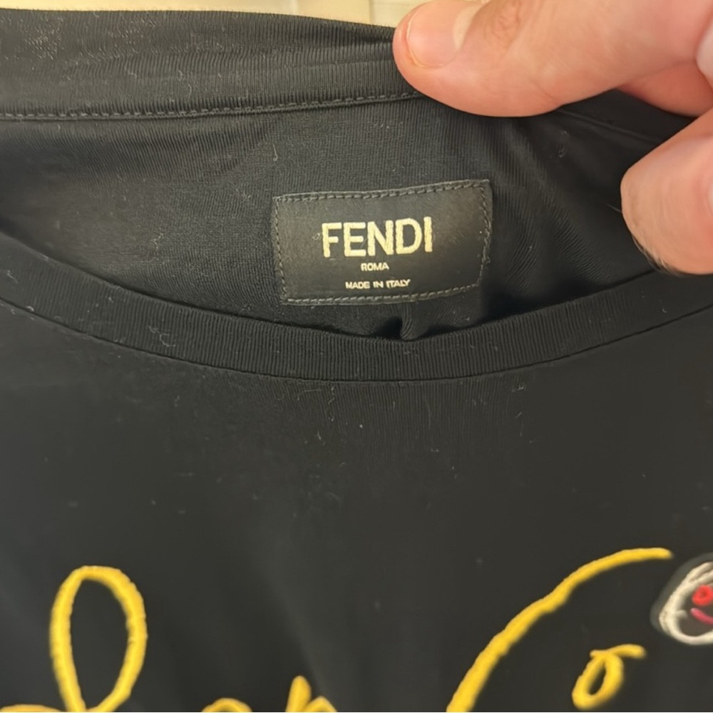 Neatly word Fendi tshirt..fit like an XL pit to pit 22